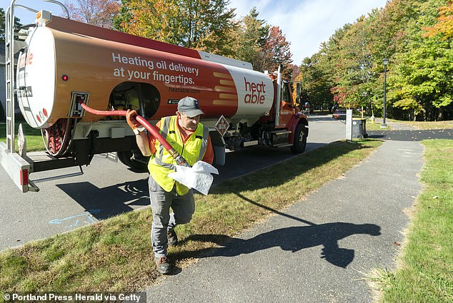 A driver delivers oil to a home in Scarborough, Maine, in October 2021