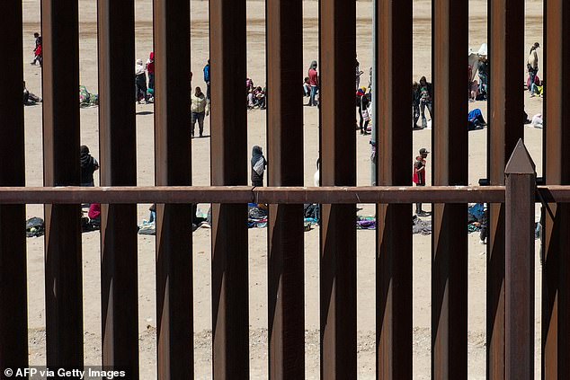 Migrants lined up at the border wall to report to U.S. Customs and Border Protection near El Paso, Texas, in May