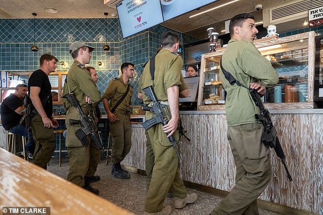 Reserve troops have responded to Israel's call in their thousands, flying from all over the world.  The photo shows soldiers in Tel Aviv taking a break from their duties to get some food and coffee