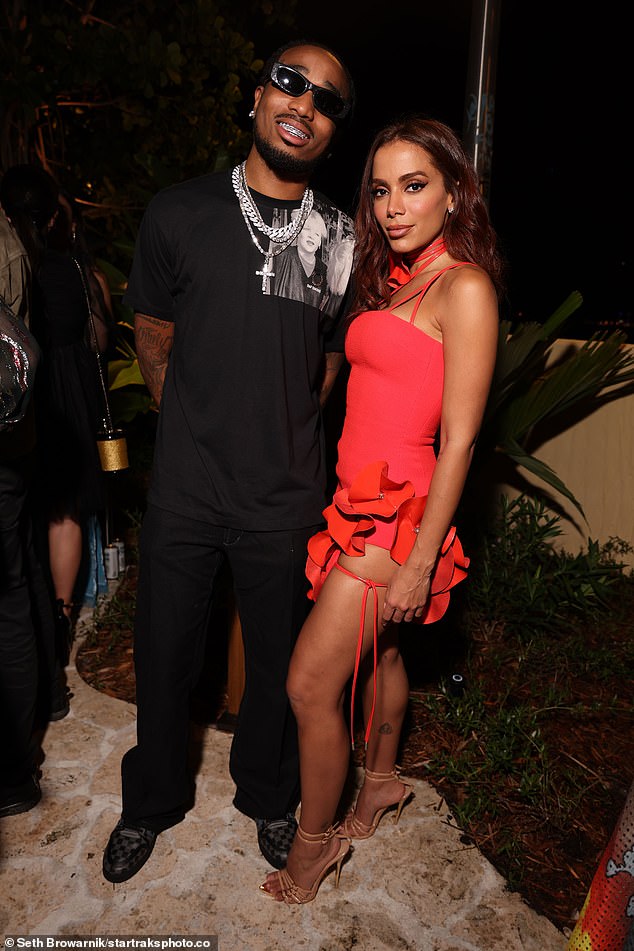 Striking: Completed his look with an oversized black T-shirt and layered necklaces (pictured with Anitta)