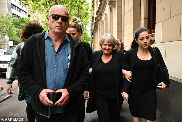 Amorosi's stepfather Peter Robinson (left), her mother Joylene (centre) and sister Natasha (right) outside the Supreme Court of Victoria