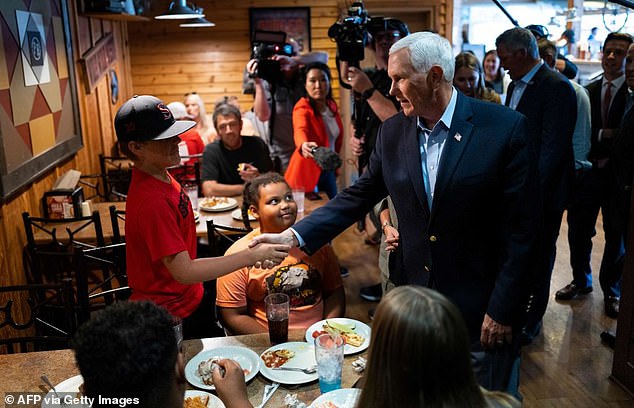 Pence greets customers at a Pizza Ranch restaurant in Waukee, Iowa, on June 8.  Another recent stop at a Pizza Ranch in Red Oak drew a crowd of just 13 people