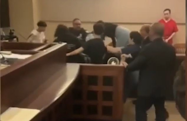 Someone captured the shocking fight on video - the footage showed a group of at least four people throwing punches at Rivas - who was handcuffed