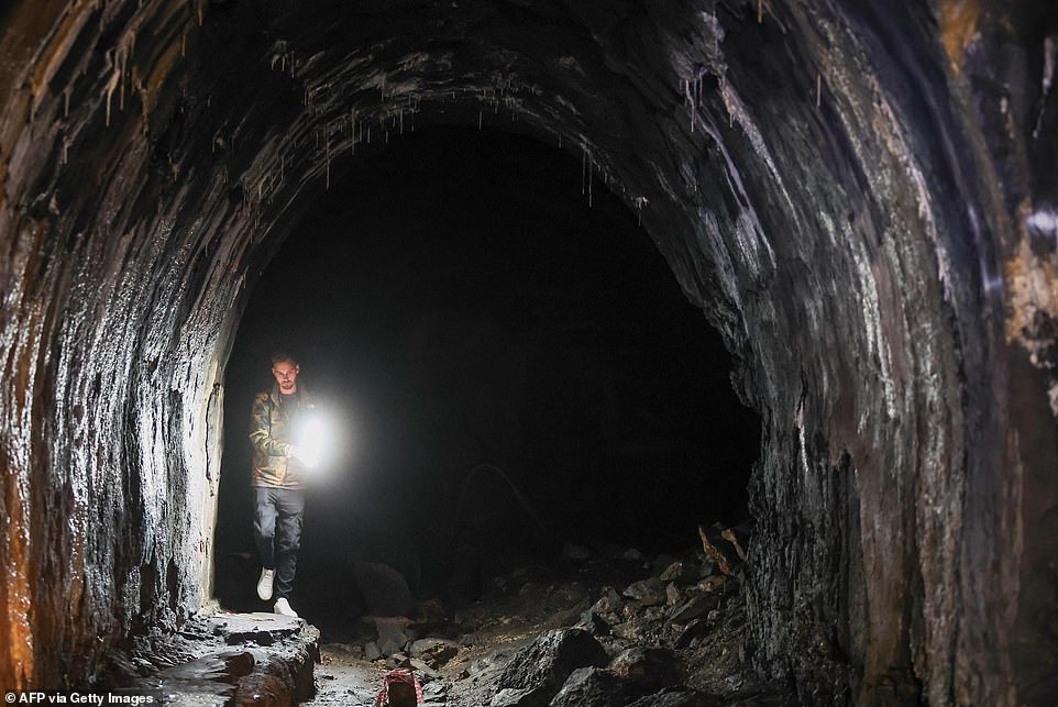 It stood stagnant after being abandoned during the Serbo-Croatian War in 1992, with only the occasional intrepid adventurer ever daring to venture into its crumbling cavernous core (pictured is Mario Garbin exploring the dank depths of the bunker explores with a torch)