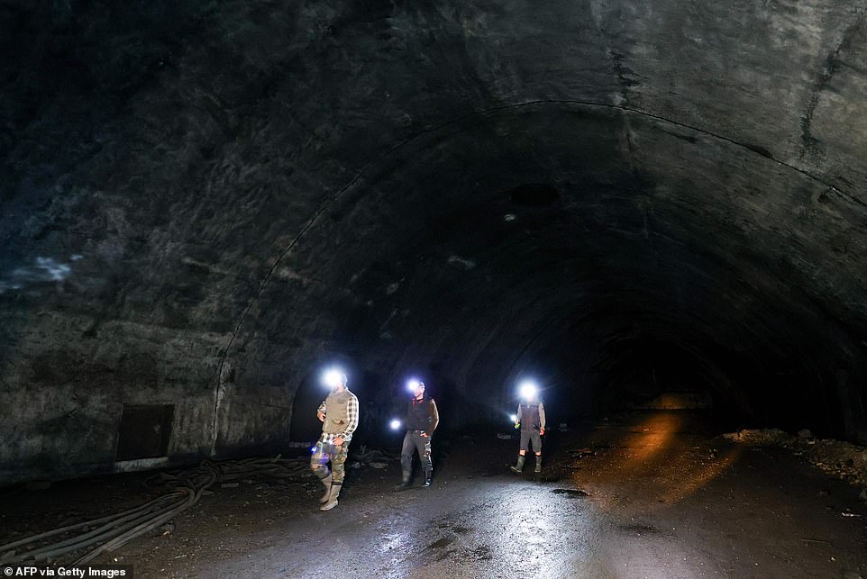 Visitors explore some of Zeljava's 3.5 kilometers of tunnels in the heart of Pljesevica Mountain on October 4, 2023