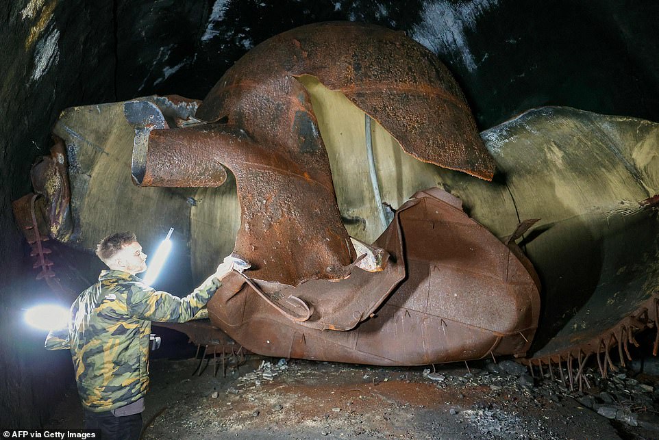 Visitor Mario Garbin looks at enormous fuel tanks on the Zeljava.  The underground base is designed to withstand a nuclear explosion