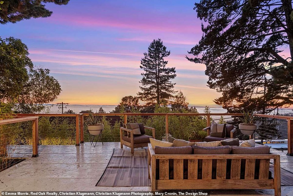 The spacious deck is surrounded by nothing but a wooden railing - so visitors can feel at one with nature during their time in the outdoor part of the property