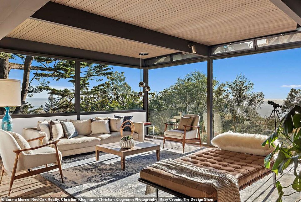 Behind the living room are floor-to-ceiling windows that bring the beautiful nature surrounding the building to the inside of the property, giving the authentic treehouse experience