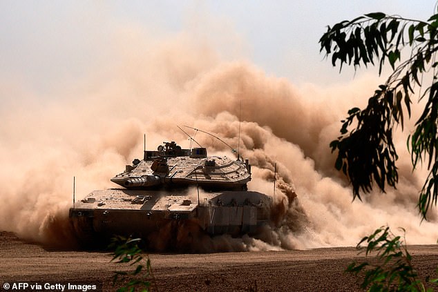 An Israeli Army Merkava battle tank is deployed along with others along the Gaza Strip border in southern Israel on October 13, 2023