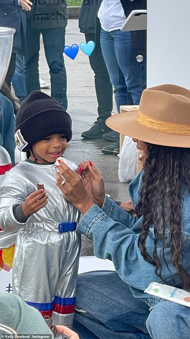 Cute: The attentive mother wiped her son's face as he was eating a sweet treat at the event