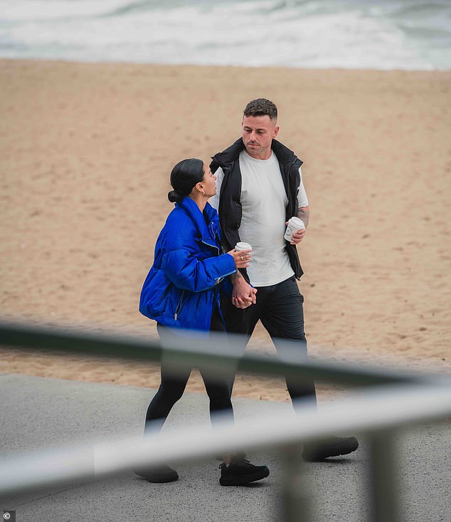 The pair strolled together with takeaway coffee cups and couldn't stop staring at each other