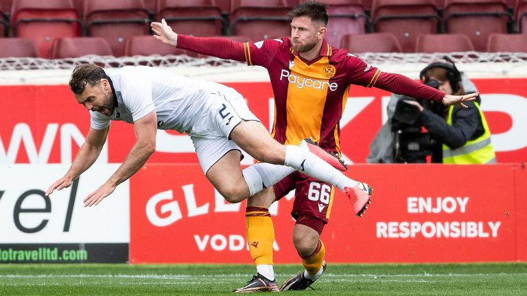 MOTHERWELL, SCOTLAND - MAY 20: Motherwell's Calum Butcher tackles County's Connor Randall, initially awarded as a penalty before referee Alan Muir fell over after a VAR check during a snappy Premiership match between Motherwell and Ross County at Fir Park, on May 20, 2023 , in Motherwell, Scotland.  (Photo by Craig Foy / SNS Group)