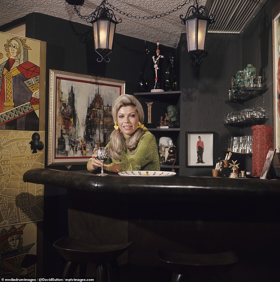 Nancy was photographed in the iconic martini bar in the living room of the house