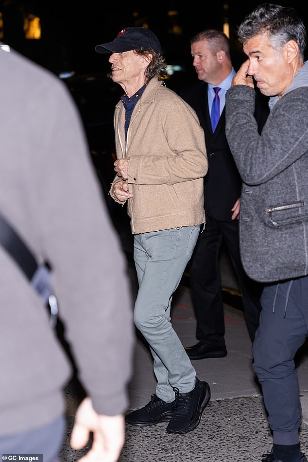 Style: Mick wore a blue shirt and camel jacket, with light green trousers and black trainers