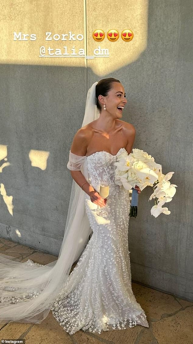 Talia looked beautiful in an off-the-shoulder dress with a lace overlay and a long train