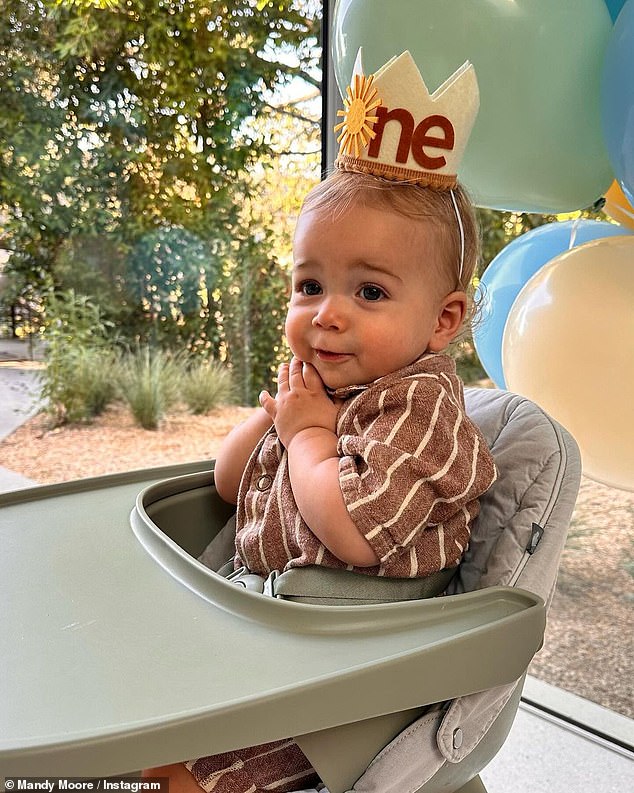 Precious: As the couple marked the special occasion surrounded by loved ones and their two-year-old Augustus, the This Is Us star, 39, beamed with happiness as her youngest sat in front of a piece of vanilla cake while wearing a crown with his age on it