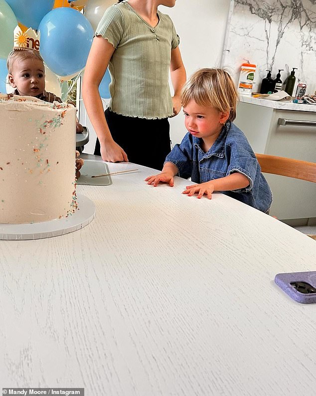 Yum!  Moore and Goldsmith's eldest seemed particularly eager to dig into the dessert as he got closer and closer to the cake as his father cut his brother the first piece.