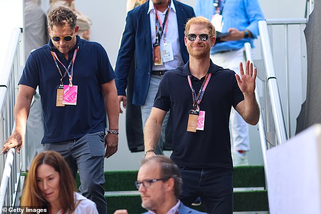 The man of the moment!  Prince Harry waved to fans as he was escorted through the paddock at the race track