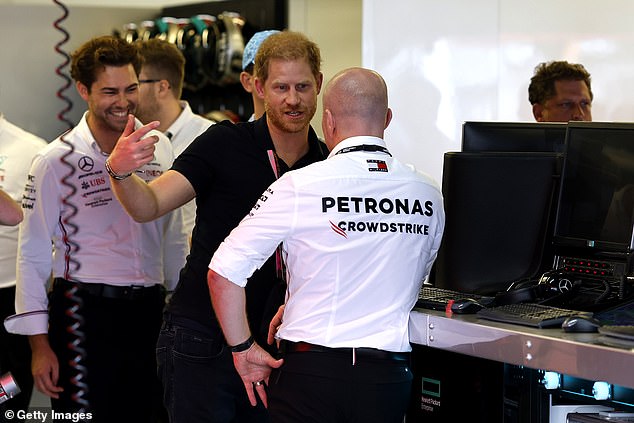 Prince Harry, 39, looked animated as he went backstage at the US Grand Prix in Austin, Texas this afternoon