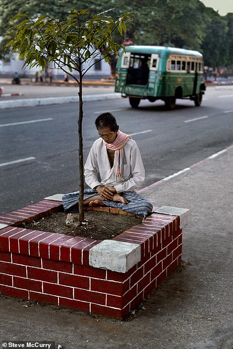 This peaceful image - taken by McCurry in 1994 - shows a man meditating as he stands in front of Sule Pagoda, a Buddhist stupa in Yangon, Myanmar's largest city