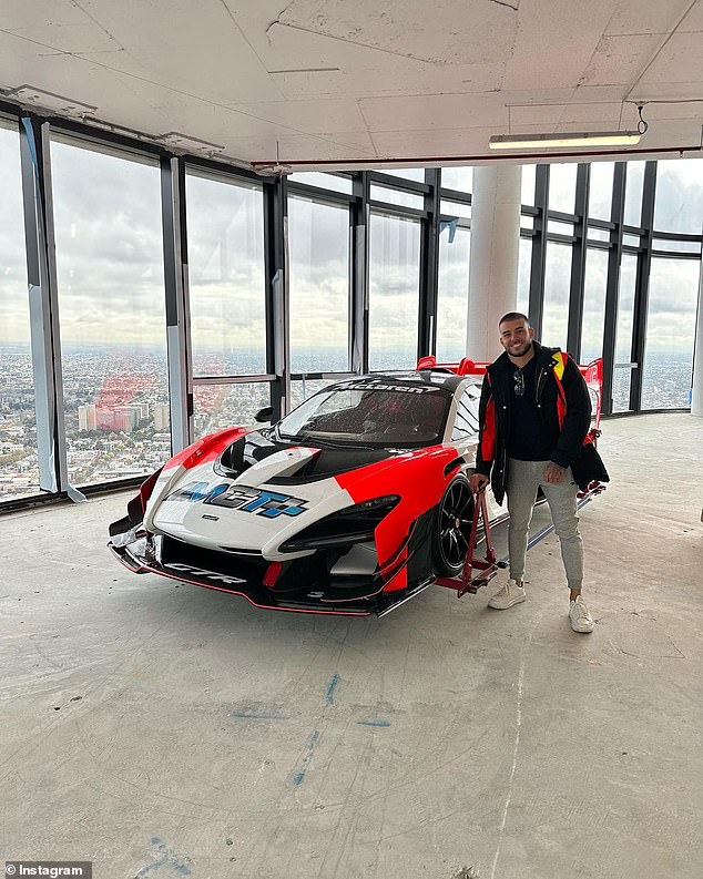 Adrian Portelli is seen with the McLaren supercar he lifted into a skyscraper in Melbourne