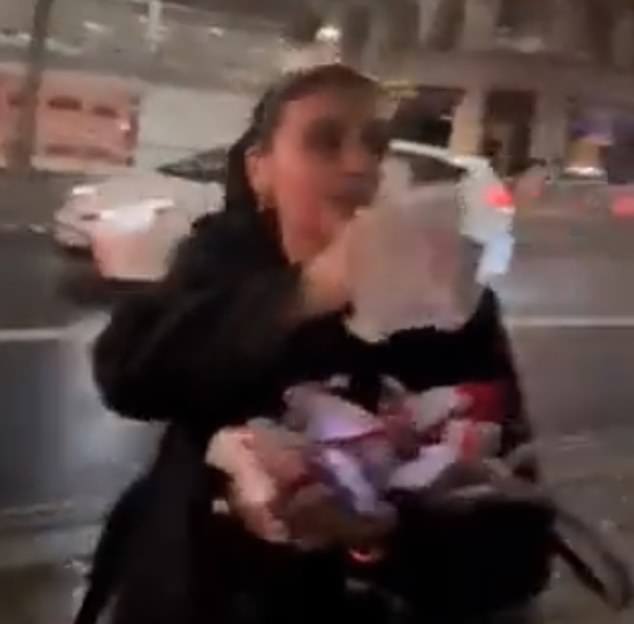 On October 7, a young woman was filmed in London, seen here holding torn posters of Israelis held hostage by Hamas.