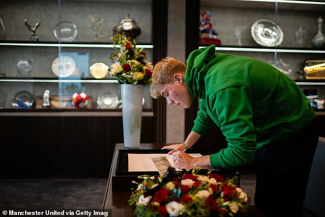 Summer recruit Rasmus Hojlund wore a green hoodie as he wrote a message