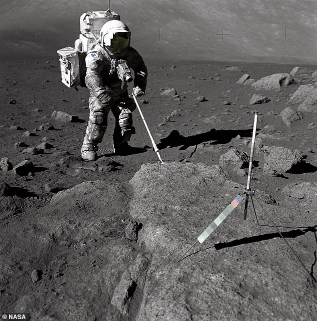 Moon crystals brought back from the last Apollo mission in 1972 have been used to estimate the moon's exact age.  Pictured: Astronaut Harrison Schmitt collects the sample during the Apollo 17 mission