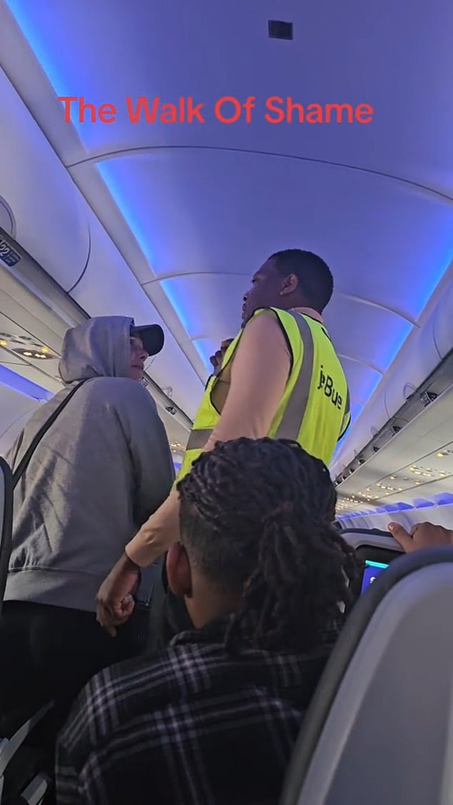 The woman was escorted off the flight by another JetBlue employee, who led passengers to their seats to applaud the outcome as she walked down the aisle