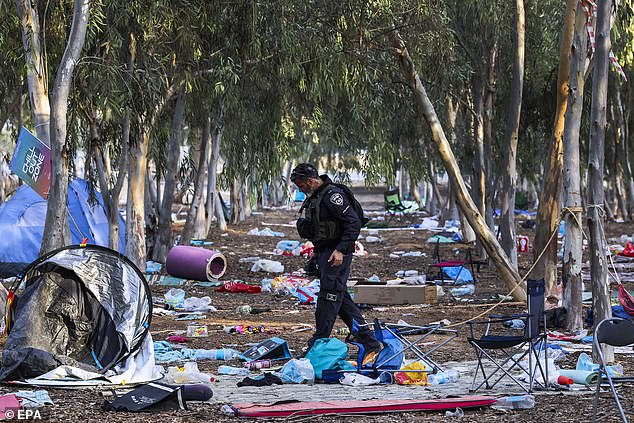 An Israeli officer walks on the grounds of the Super Nova Festival in Re'im, Israel, October 17, 2023, which was attacked by Hamas on October 7.  Israel has pledged to eradicate Hamas in response