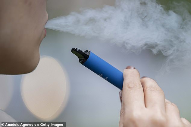 A massive increase in the number of children and teenagers taking up vaping could lead the government to restrict vape flavors, regulate their packaging and change point-of-sale displays, and even ban the devices entirely.  Pictured: File image of a woman vaping