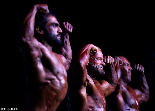 Male bodybuilders compete on stage during the IBFA British Finals Night of Champions competition at the Federation Brewery in Gateshead