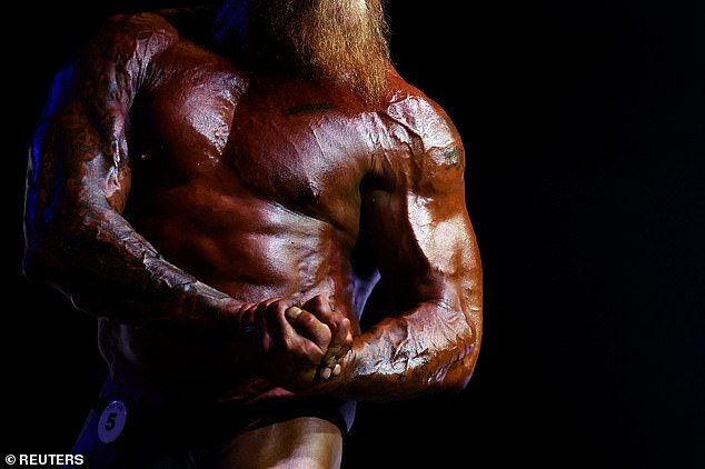 Male bodybuilder Paul Chadwick competes on stage.  The IBFA uses 'old school' methods