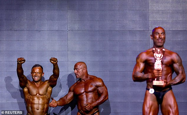 Bodybuilder Mark Law celebrates victory during the IBFA British Finals Night of Champions competition