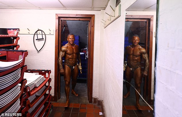 Bodybuilder Mark Law with his winning trophy backstage.  About 85 people took part in the competition this year