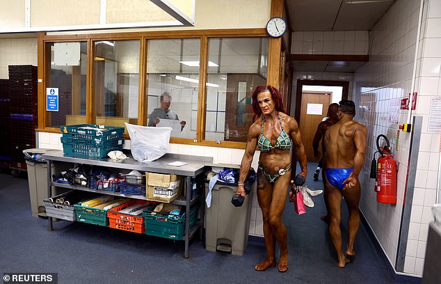 Bodybuilders walk backstage.  The IBFA organizes numerous bodybuilding shows in the United Kingdom