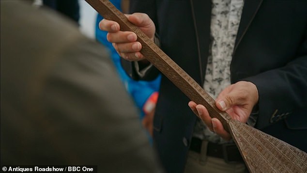 Complicated: Adam analyzed the complicated paddle, which he thought was from the 19th century