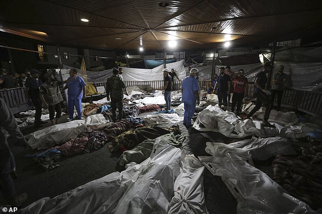 Bodies of Palestinians killed by an explosion at Ahli Arab hospital were gathered in the front yard of al-Shifa hospital on Tuesday