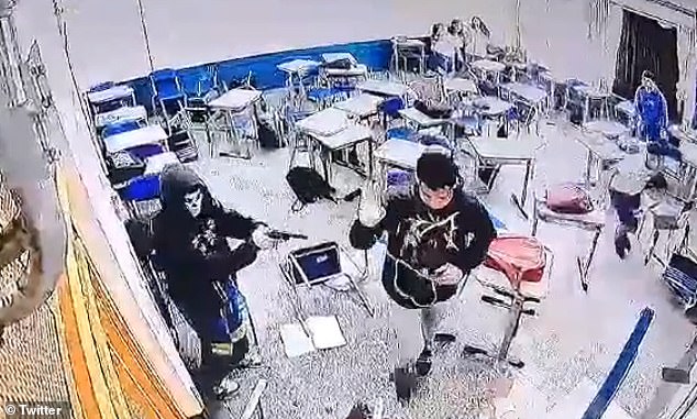 The student points his gun at a classmate from Sapopemba State School.  Brazilian news outlet Metropoles spoke to students who claimed the gunman was bullied because he was gay and planned the attack two weeks ago with three other classmates, including a lesbian.