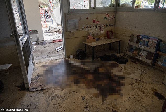 There is a pool of blood on the floor of an Israeli children's room, next to children's books and toys