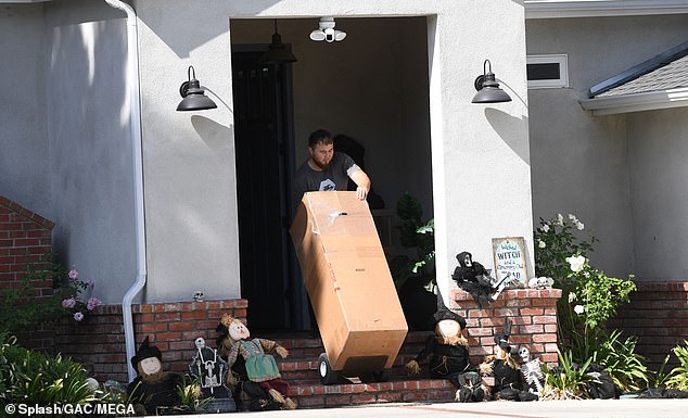 DailyMail.com spotted movers taking her belongings from the four-bedroom rental home in Woodland Hills, California on Sunday