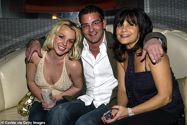 The pop star said after her brother Bryan (pictured centre) told their mother Lynne (right) that she had been punished, Bryan followed her taking pictures as she cried (pictured in 2006)