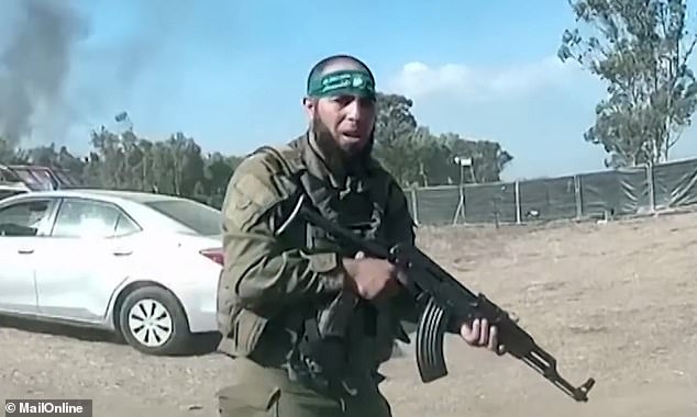 There is a photo of a Hamas gunman storming Israeli positions on October 7