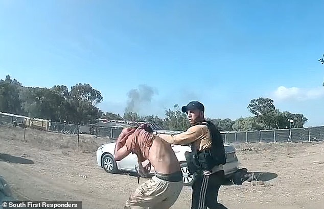 Previously seen footage shows a Hamas gunman taking a civilian hostage after shooting many others in cold blood.  MailOnline has requested unedited, unseen footage from the Israeli government news agency