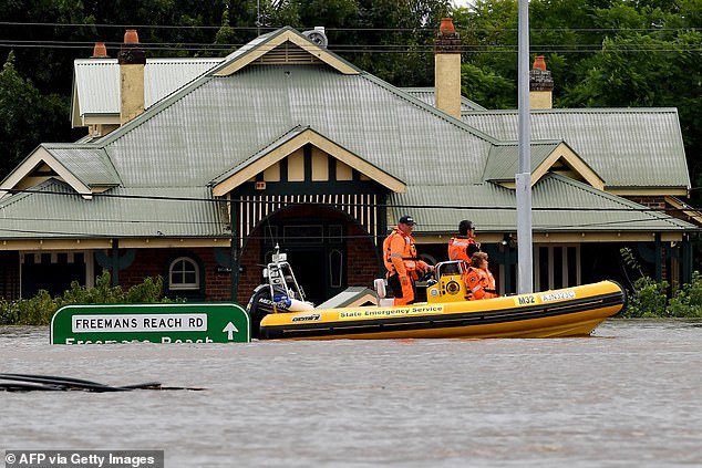 Rescue volunteers patrol the flooded homes next to the old Windsor Bridge along the flooding Hawkesbury River in the Sydney suburb of Windsor on March 9, 2022