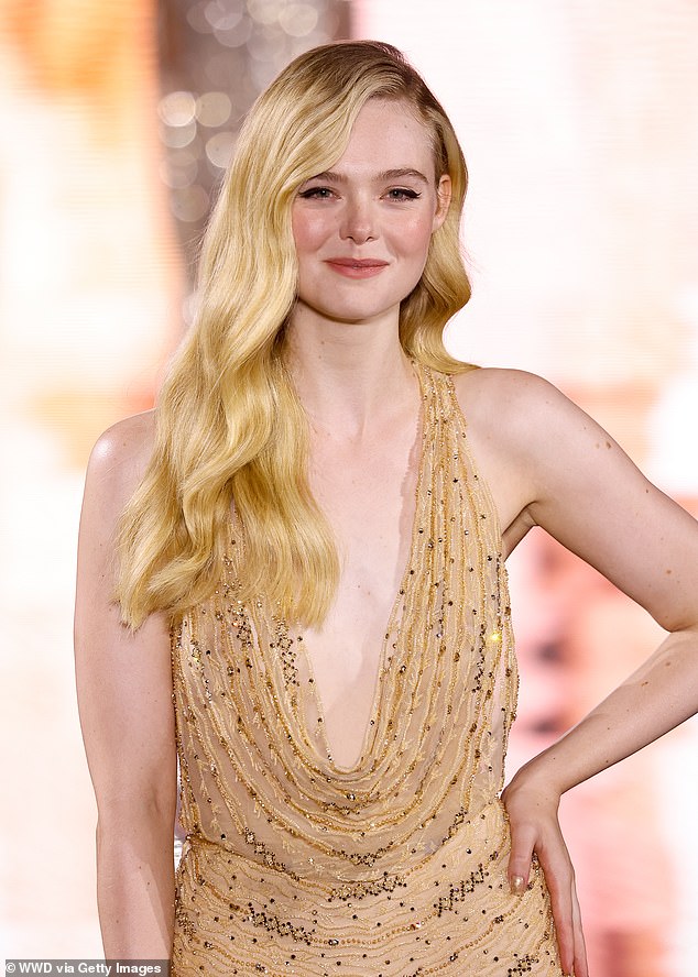 Wow factor: For the runway show, Elle stunned in a gold dress with a draped neckline and intricate beadwork.  The blonde beauty chose to wear her long locks in Old Hollywood waves for a classic look;  seen during the event on October 1, 2023 in Paris, France, at the Eiffel Tower