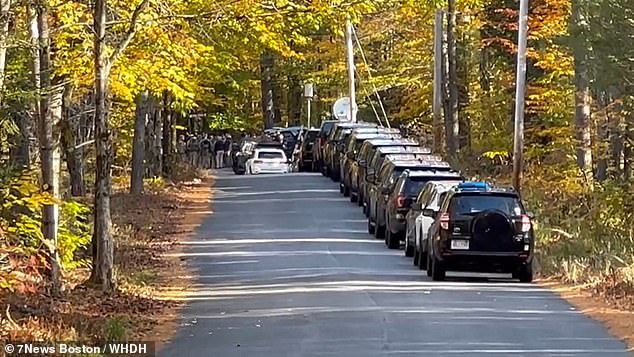 A line of law enforcement vehicles on the scene, with several agencies including the state's Special Tactical Operations team assisting the manhunt