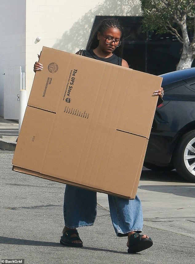 The recent graduate was seen carrying a handful of boxes from a UPS store