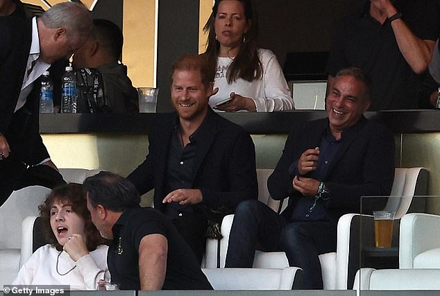 In the photo, Harry watches the match from his seat in the director's box at the stadium, which costs thousands of dollars to rent