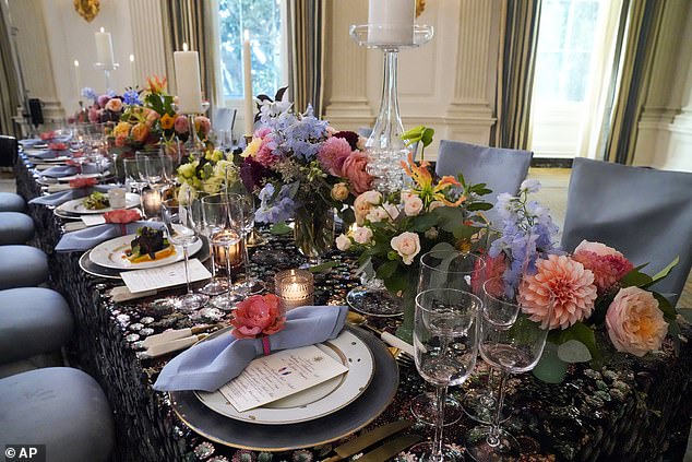 The table setting consists of colorful flowers and candles